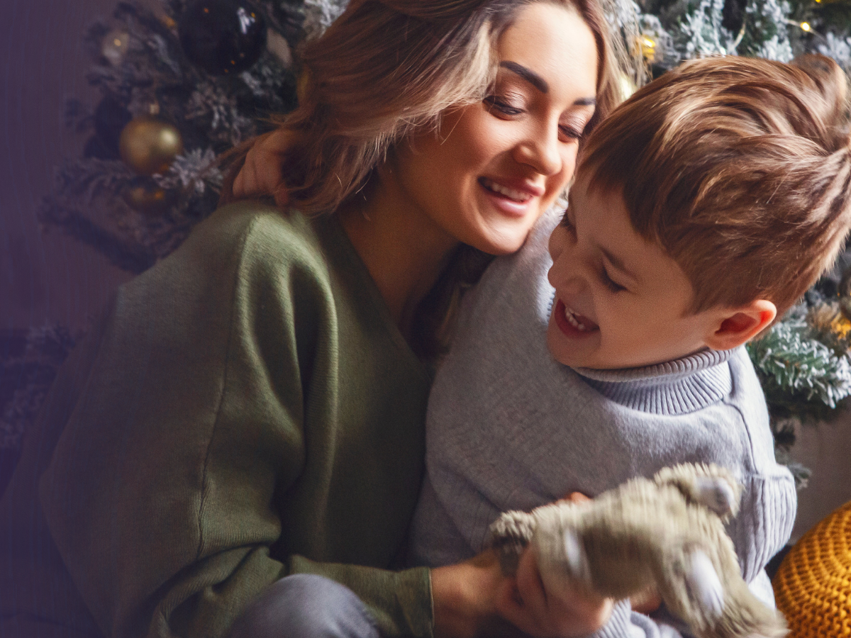A mother and young son sharing a close, joyful moment.
