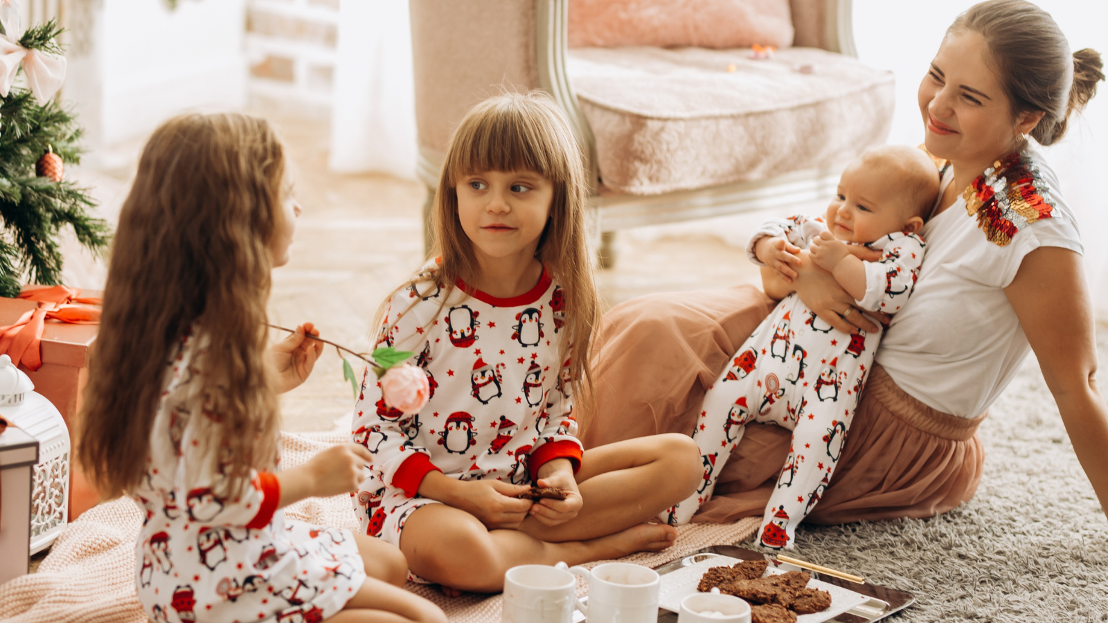 Children in holiday pajamas playing together at home.
