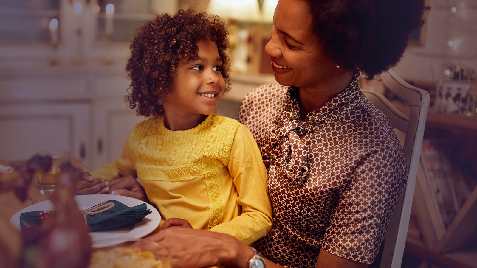 A mother and daughter embracing warmly.